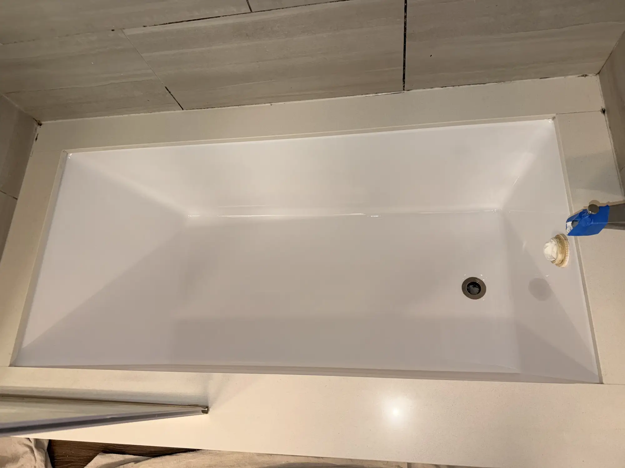 The same bathtub after refinishing, restored glossy white finish