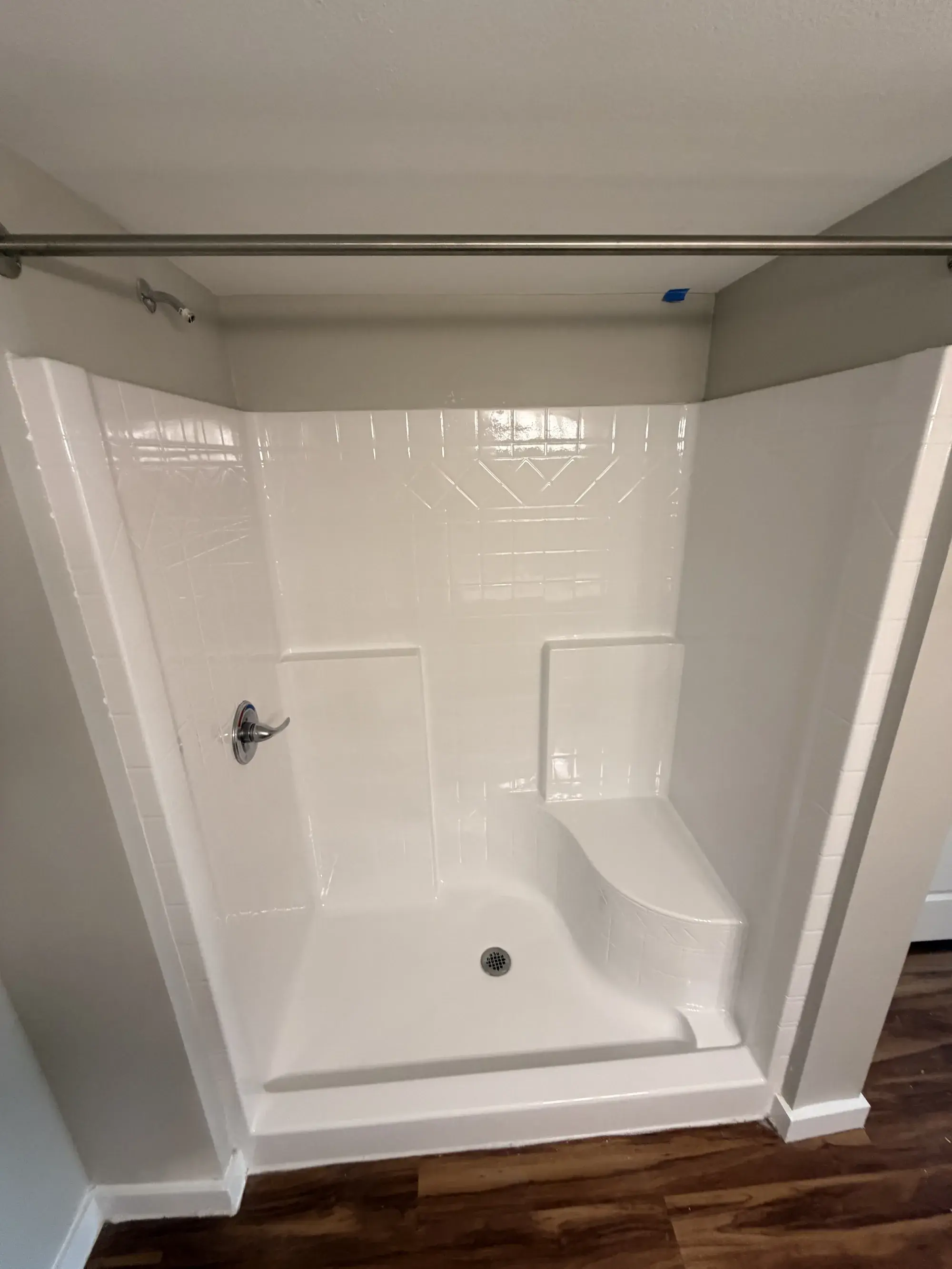 Refinished shower with a built-in seat